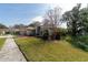 Single-story home with a well-manicured front lawn, mature trees, and tasteful landscaping at 3037 Crest Dr, Clearwater, FL 33759