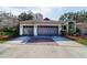 A two car garage with doors and concrete driveway at 3037 Crest Dr, Clearwater, FL 33759