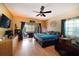 Relaxing main bedroom with a ceiling fan, dresser, and sliding glass door to the outdoors at 3037 Crest Dr, Clearwater, FL 33759