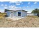 Backyard view featuring a back door, patio, and partial fencing at 3246 Thorny Ridge Dr, Holiday, FL 34691