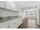 Bright kitchen with lots of white cabinets, gray marbled granite counters, and stainless steel appliances at 3246 Thorny Ridge Dr, Holiday, FL 34691