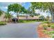 Welcoming clubhouse entrance featuring well-maintained landscaping and convenient covered drop-off areas at 3373 Brodie Way, Palm Harbor, FL 34684