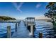 Dock and boat lift are located on a large body of water with clear, blue skies at 3373 Brodie Way, Palm Harbor, FL 34684