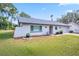 Charming single-story home with well-manicured lawn and an attached two-car garage on a sunny day at 3373 Brodie Way, Palm Harbor, FL 34684