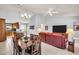 Open-concept living room with a vaulted ceiling, tile flooring, and plenty of natural light at 3373 Brodie Way, Palm Harbor, FL 34684