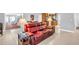 Bright living room featuring tile flooring and comfortable red leather sofa at 3373 Brodie Way, Palm Harbor, FL 34684