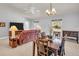 Open concept living room featuring tile flooring, a ceiling fan, and natural light at 3373 Brodie Way, Palm Harbor, FL 34684