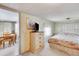 Serene bedroom with floral accents and a view into the dining area at 36947 Beth Ave, Zephyrhills, FL 33542