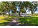 Exterior of community clubhouse and picnic tables on the lawn at 36947 Beth Ave, Zephyrhills, FL 33542