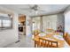 Dining area with a wooden table and chairs, with a view of the kitchen and sliding glass doors at 36947 Beth Ave, Zephyrhills, FL 33542