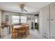 Bright dining room featuring a wooden table, matching chairs, and a ceiling fan at 36947 Beth Ave, Zephyrhills, FL 33542