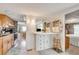 Well-lit area between the kitchen and bedroom with a breakfast bar and wooden stool at 36947 Beth Ave, Zephyrhills, FL 33542