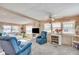 Bright living room with neutral walls, a ceiling fan, and large windows at 36947 Beth Ave, Zephyrhills, FL 33542