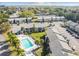 Community aerial view featuring a pool, palm trees and convenient parking at 4215 E Bay Dr # 900, Clearwater, FL 33764