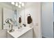 Bathroom vanity with large mirror and convenient lighting at 4215 E Bay Dr # 900, Clearwater, FL 33764