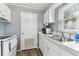 Bright kitchen with white cabinets and stainless steel sink under a window at 4215 E Bay Dr # 900, Clearwater, FL 33764