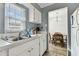 Kitchen features stainless steel sink, white cabinets, and natural light from a window at 4215 E Bay Dr # 900, Clearwater, FL 33764