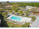 Aerial view of a community pool surrounded by mature trees and lounge chairs at 4215 E Bay Dr # 900, Clearwater, FL 33764