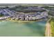 Panoramic aerial view of lakeside homes with a walking path bordering the lake and community at 4594 Tour Trce, Land O Lakes, FL 34638