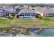 Aerial of the backyard showcasing the screen enclosed pool, backyard, and pond at 4594 Tour Trce, Land O Lakes, FL 34638