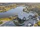 Aerial view of the clubhouse and community lake, highlighting the serene surroundings and amenities at 4594 Tour Trce, Land O Lakes, FL 34638