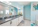 Well-lit bathroom featuring double vanity with granite countertop, modern fixtures, and a large mirror at 4594 Tour Trce, Land O Lakes, FL 34638