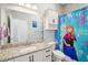 bathroom with Frozen-themed shower curtain, white cabinetry, and granite vanity top at 4594 Tour Trce, Land O Lakes, FL 34638