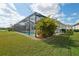 Beautiful screened pool area with lush landscaping at 4594 Tour Trce, Land O Lakes, FL 34638