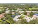 Aerial view of the property, lush trees, waterfront location, serene pond and well maintained landscaping at 4620 Hidden View Pl # 10, Sarasota, FL 34235