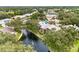 Aerial view showcasing lush trees, waterfront location, fountain and well maintained landscaping at 4620 Hidden View Pl # 10, Sarasota, FL 34235