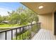 Balcony view of lake and landscaping, with a ceiling light at 4620 Hidden View Pl # 10, Sarasota, FL 34235