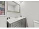 Bathroom features a gray vanity with marble countertop and framed mirror at 4620 Hidden View Pl # 10, Sarasota, FL 34235