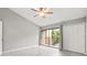 Bright bedroom with ceiling fan, sliding doors to a balcony, and closet at 4620 Hidden View Pl # 10, Sarasota, FL 34235