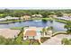 Aerial view showcasing pool and spa surrounded by lush landscaping with lounge chairs and covered seating at 4620 Hidden View Pl # 10, Sarasota, FL 34235