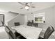 Open-concept dining room showcasing a marble table, ceiling fan, and a glimpse into the bright kitchen at 4620 Hidden View Pl # 10, Sarasota, FL 34235