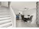 Bright dining area featuring tile floors, modern decor, and a staircase leading to the upper level at 4620 Hidden View Pl # 10, Sarasota, FL 34235