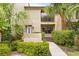 Charming townhouse featuring lush tropical landscaping and a cozy second-story balcony at 4620 Hidden View Pl # 10, Sarasota, FL 34235