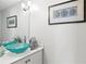 Stylish bathroom with marble countertops, modern fixtures, and uniquely designed glass vessel sinks at 4810 W San Miguel St, Tampa, FL 33629