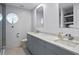 Bathroom featuring double sink vanity, round window and modern fixtures at 4810 W San Miguel St, Tampa, FL 33629