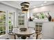 Cozy dining area with elegant lighting fixture, a round dining table, and french doors to the outside at 4810 W San Miguel St, Tampa, FL 33629