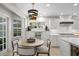 Bright dining area with a round table, modern lighting, and access to outdoor views at 4810 W San Miguel St, Tampa, FL 33629