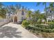 Two-story home with a stucco exterior, manicured landscaping and a long driveway at 4810 W San Miguel St, Tampa, FL 33629