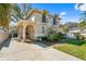 Two-story home featuring a stucco exterior, wrought iron gate, and a long driveway at 4810 W San Miguel St, Tampa, FL 33629