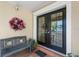 Home's front porch featuring tile flooring, wreath, bench, and decorative molding around a double door entrance at 4810 W San Miguel St, Tampa, FL 33629