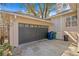 Attached two-car garage with modern door and exterior trash cans, providing convenient parking at 4810 W San Miguel St, Tampa, FL 33629