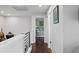 Second floor hallway with hardwood floors leading to a bedroom at 4810 W San Miguel St, Tampa, FL 33629