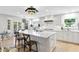 Bright kitchen with white cabinets, marble countertops, a large island, and stylish pendant lighting at 4810 W San Miguel St, Tampa, FL 33629