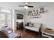 Bright living room featuring hardwood floors, built-in shelving, and French doors at 4810 W San Miguel St, Tampa, FL 33629