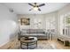 Comfortable living room with a neutral color palette, ample seating, and natural light from large windows at 4810 W San Miguel St, Tampa, FL 33629