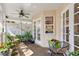 Covered porch featuring seating and a variety of potted plants at 4810 W San Miguel St, Tampa, FL 33629